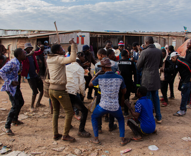 a large group of males looking very excited with arms raised