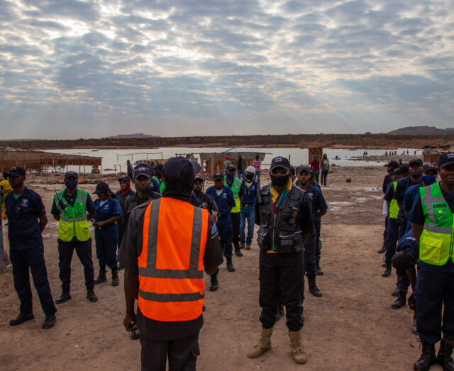 security personnel standing in high-vis vests