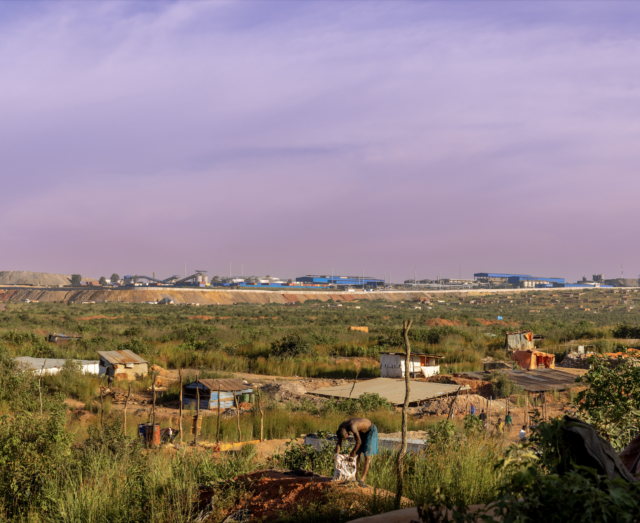 an image showing the long-shot view of the Kamilombe mine set, nestled between industrial mining operations